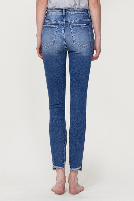 HIGH RISE ANKLE SKINNY W UNEVEN HEM DETAIL