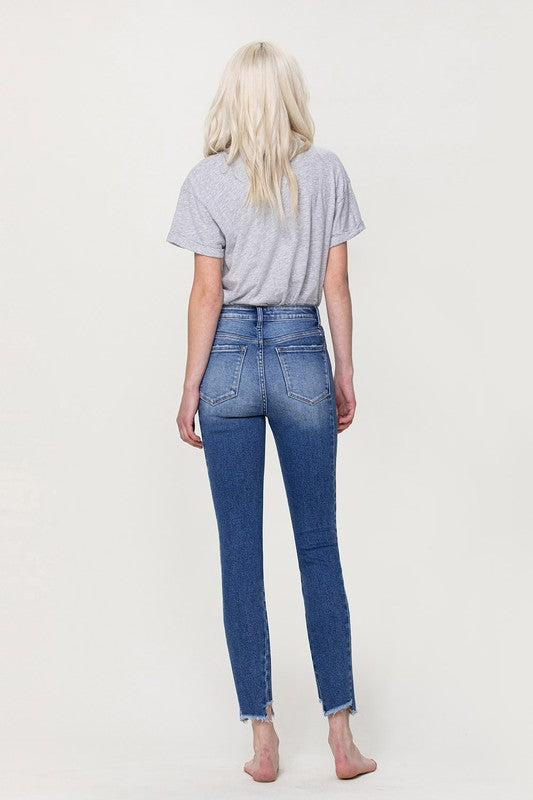 HIGH RISE ANKLE SKINNY W UNEVEN HEM DETAIL